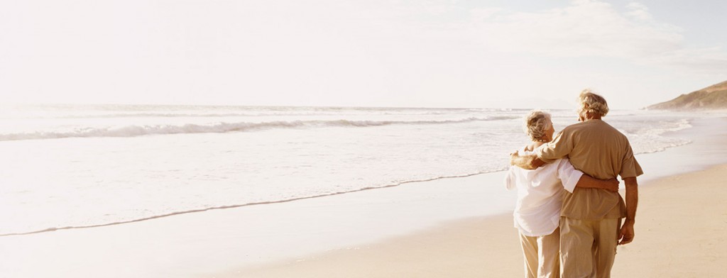 Couple walking on beach happily after christian marriage counseling