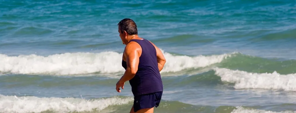 Person jogging beside the sea