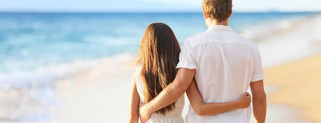 Couple walking together beside the sea
