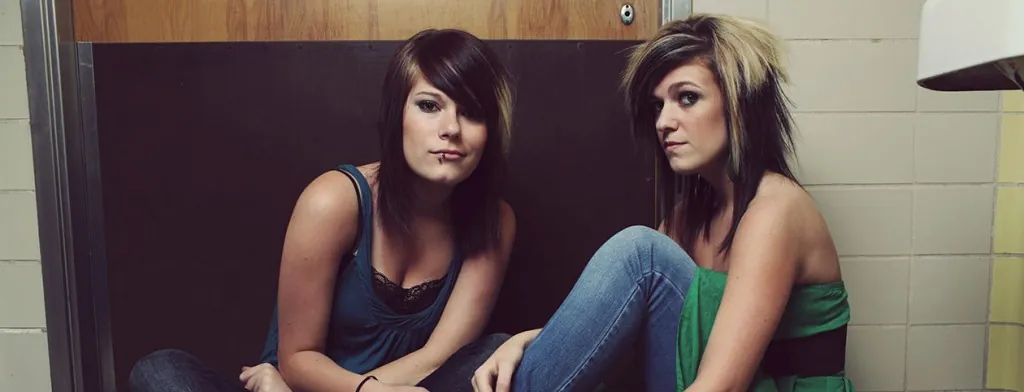 Two young women talking indoors
