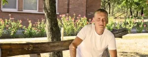 Man seated on an outdoor bench