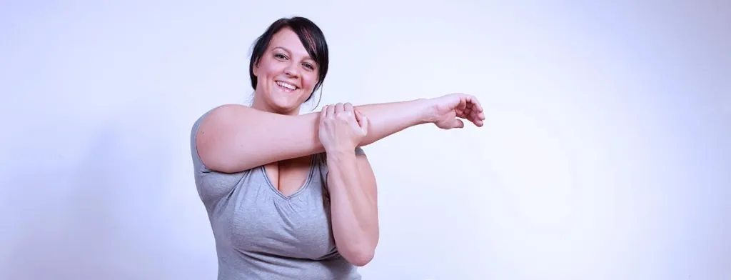 Woman stretching her arm across her chest
