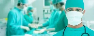 Medical professional wearing a mask and surgical cap
