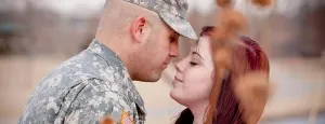 Person in military uniform embracing a partner