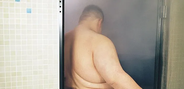 Person sitting in a steam room