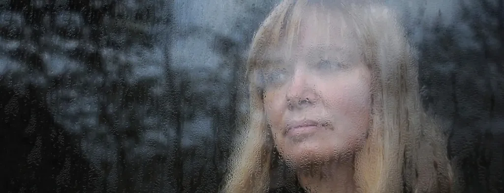 Woman looking through a window