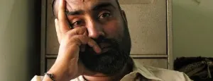 Man sitting with a hand against his face