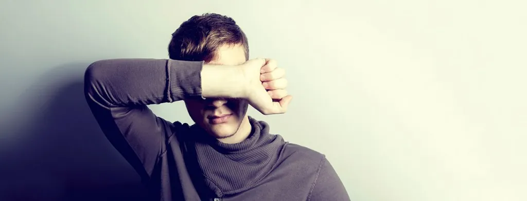 Woman resting her head against her arm