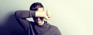 Woman resting her head against her arm