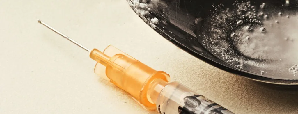Syringe beside a spoon