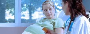 Pregnant woman speaking with a clinician
