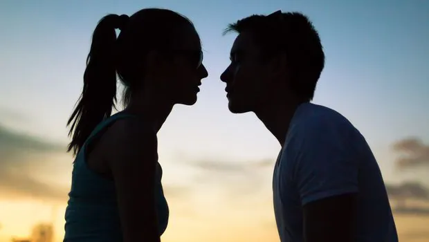 Silhouettes of two people facing each other