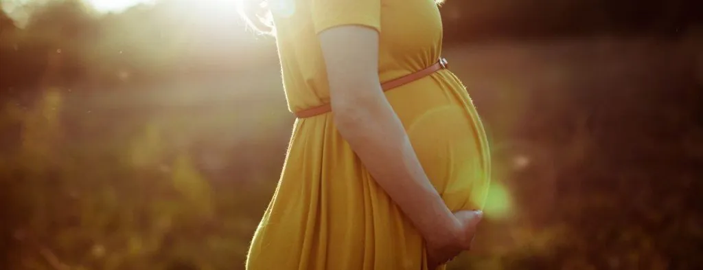 Pregnant woman standing outdoors