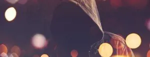 Silhouette of a person against blurred city lights