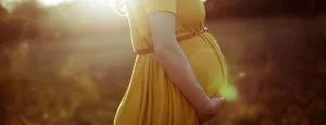 Pregnant woman standing outdoors