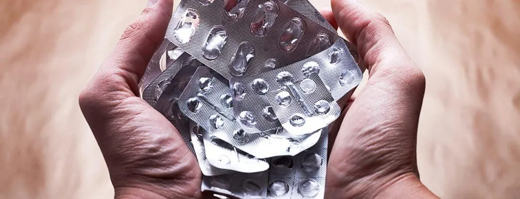 Hands holding empty medication blister packs