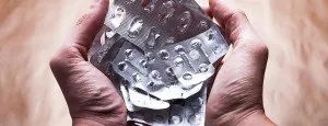 Hands holding empty medication blister packs