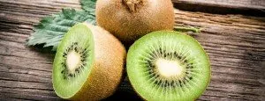 Whole and halved kiwi fruit