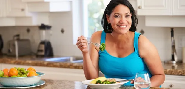 Woman sitting at a table with a meal