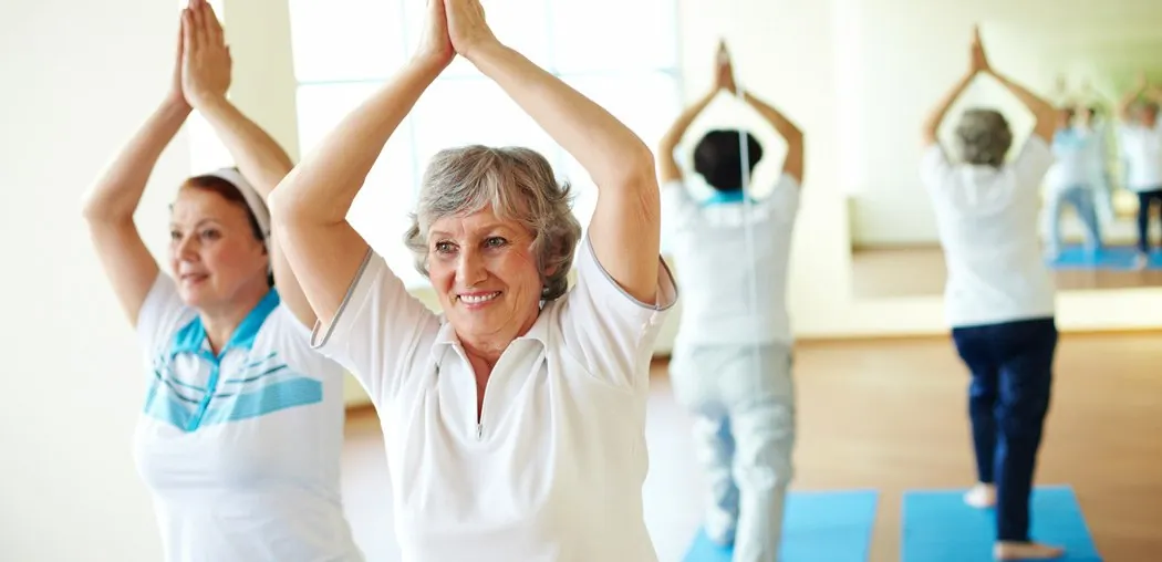 Women stretching with their arms raised