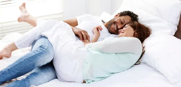 Couple embracing on a bed