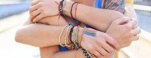 People holding one another's forearms