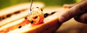 Hands preparing food with a kitchen knife