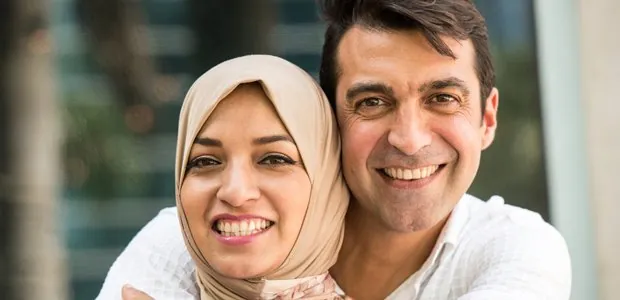 Smiling couple standing close together