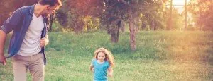 Adult and child running outdoors