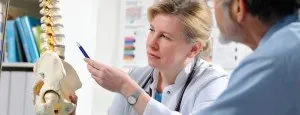 Clinician discussing a spine model with a patient