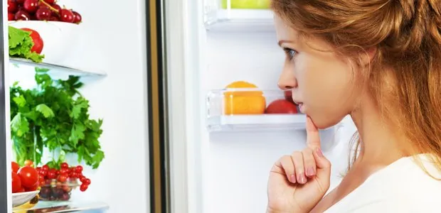 Woman looking inside a refrigerator