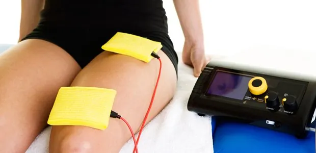 Electrical stimulation pads placed on a person's thigh