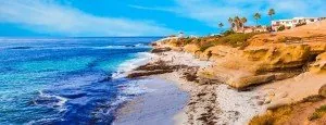 Rocky California coastline beside blue water