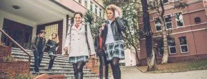 Young people walking outside a school building