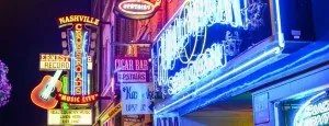 Illuminated signs on a city street at night