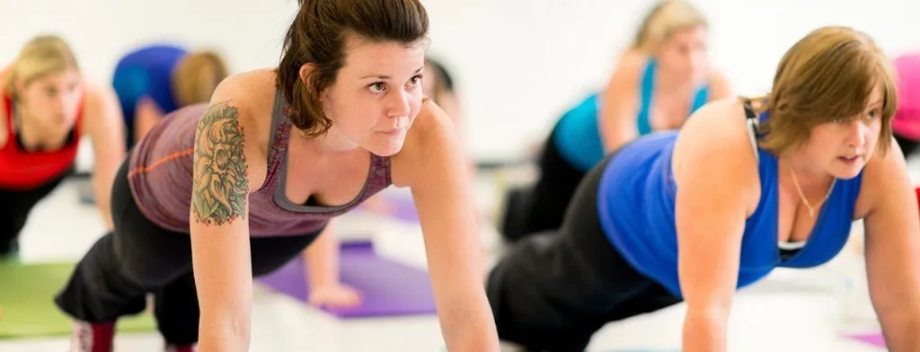 Group performing floor exercises in a fitness class
