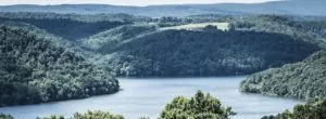 Lake surrounded by wooded hills