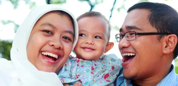 Parents smiling with their child