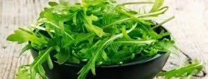 Fresh arugula leaves in a bowl