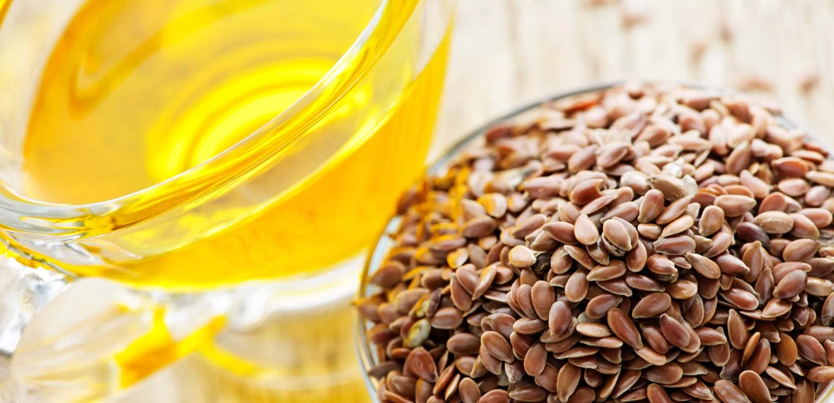 Flax seed oil beside flax seeds