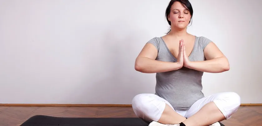 Woman seated on the floor in a yoga pose