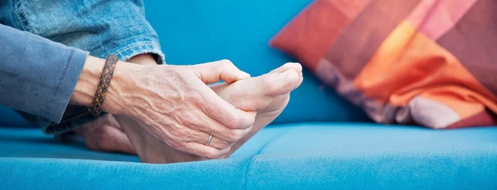 Older person's hands holding a small exercise weight