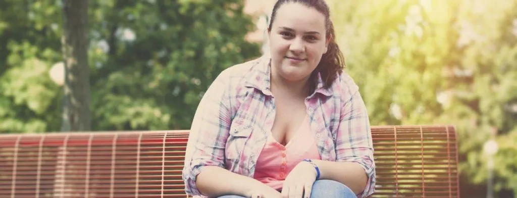 Young woman sitting on a park bench