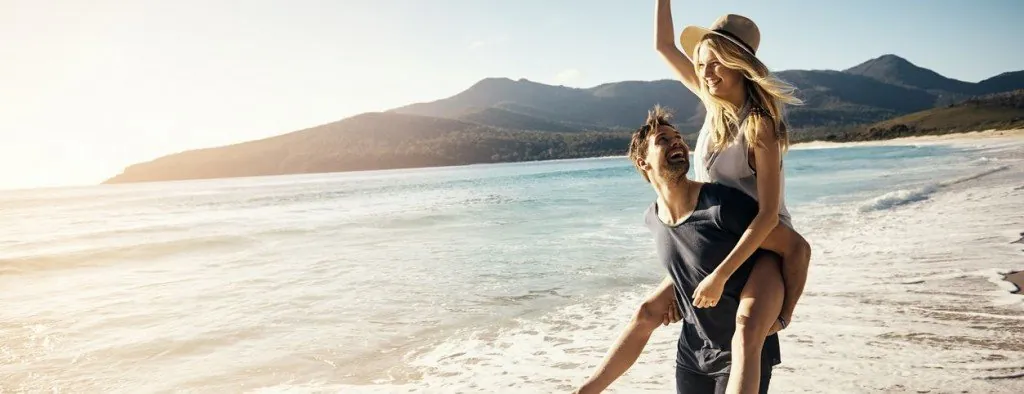 Couple playing together on a beach