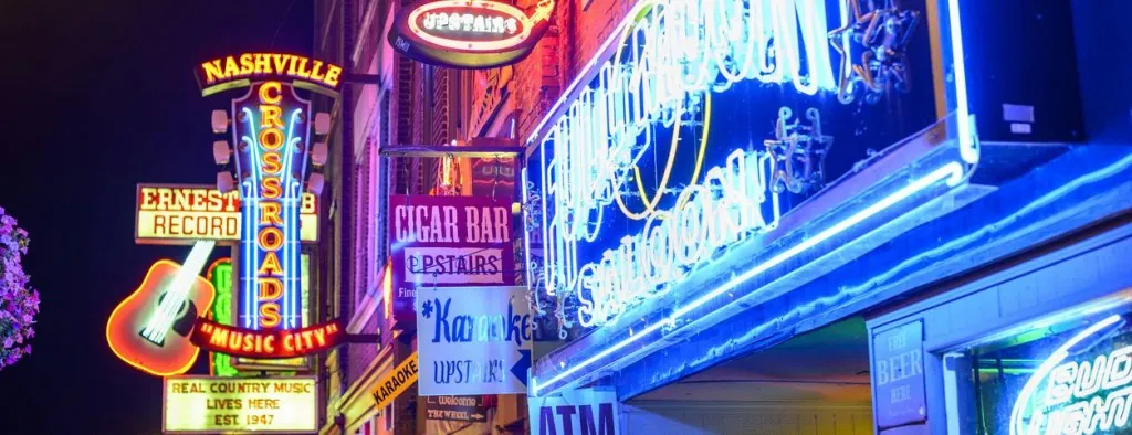 Illuminated signs on a city street at night