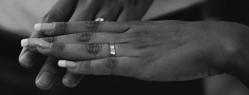 Hands wearing wedding rings