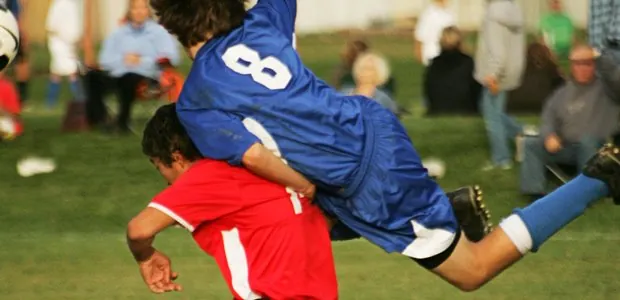 American football players during a tackle