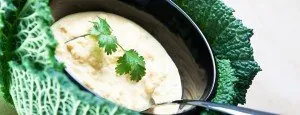 Bowl of soup with cabbage and a spoon