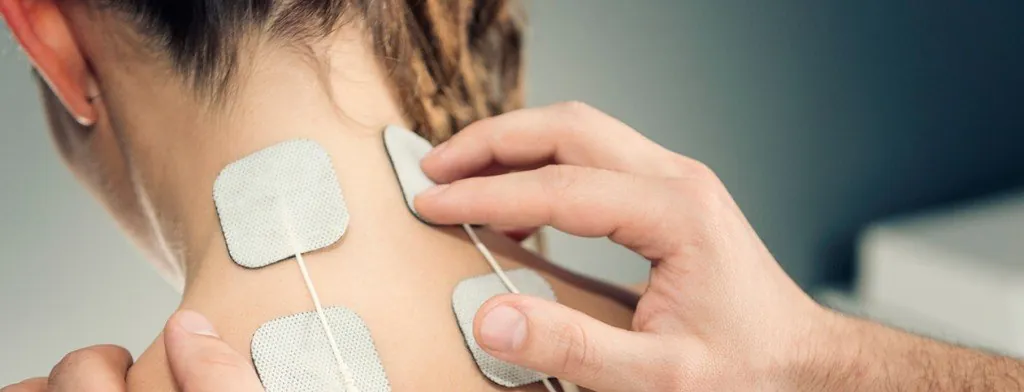 Electrode pads on a person's neck and upper back