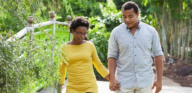 Couple walking together along a garden path